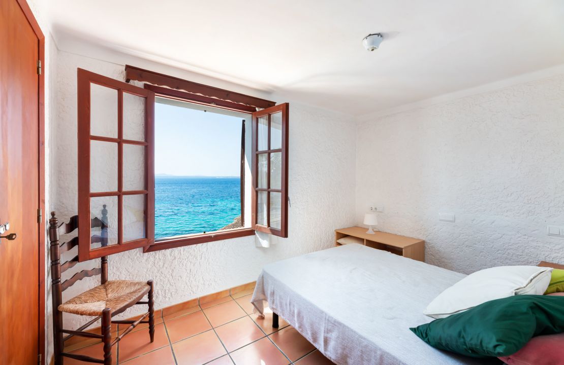 Second line Mediterranean beach house in Alcudia, Alcanada with stunning sea views and rental license