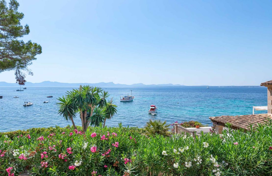 Second line Mediterranean beach house in Alcudia, Alcanada with stunning sea views and rental license